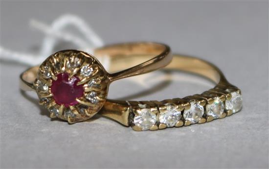 A ruby and diamond cluster ring and one other ring.